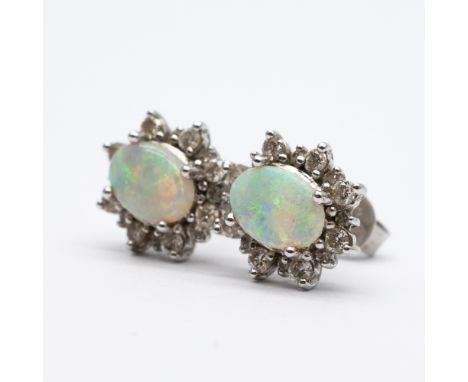 A pair of 18ct white gold opal and diamond earrings,
11mm x 10mm in size,
opal is 6mm x 4mm surrounded by diamonds,
very nice