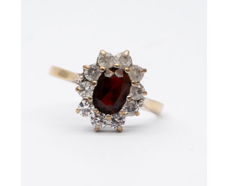 A 9ct yellow gold cz garnet dress ring,
size M,
2.3 grams approx weight