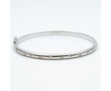 An 18ct white gold diamond set bangle,
set with 11 diamonds,
8 grams in weight approx,
very nice condition