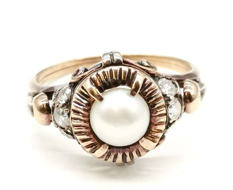 Antique diamond and pearl set ring in unmarked gold (touch tests as 15ct) with white metal detail to head &amp; set with 6 di
