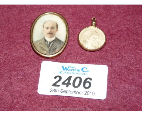 A 9ct gold pendant circular keepsake photograph holder 16mm diameter and containing two sepia images of a young lady and a ye