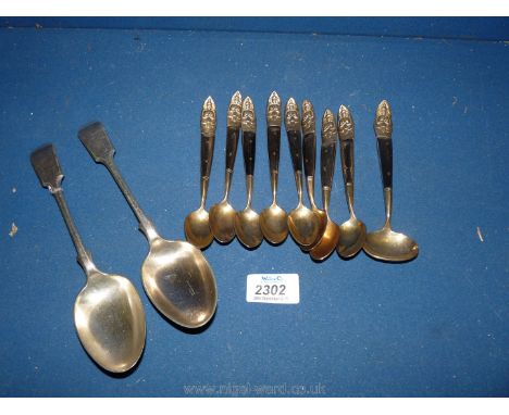 A pair of A1 silver plated fiddle handled Tablespoons and an unusual set of eight yellow metal Spoons and a small ladle style