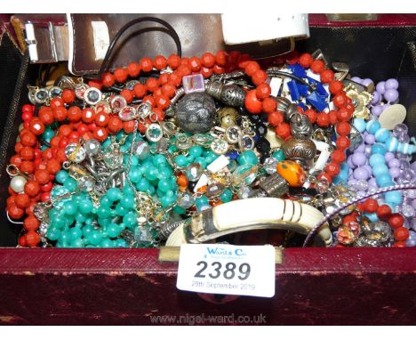 A vintage jewellery box containing costume jewellery 
