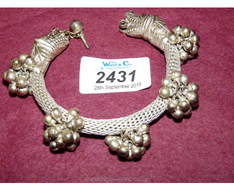 An Indian plated Bangle with chain clasp.