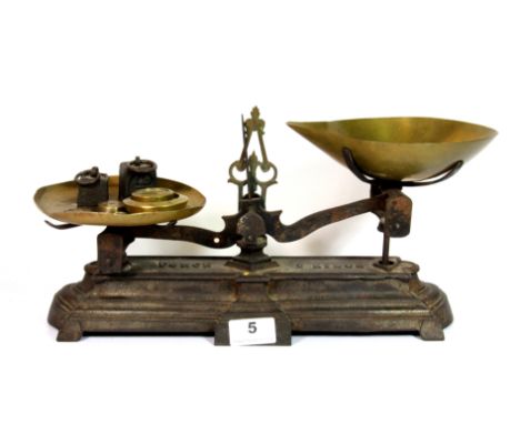 A 19th century Force 2kg cast iron and brass scale and weights, W. 36cm.