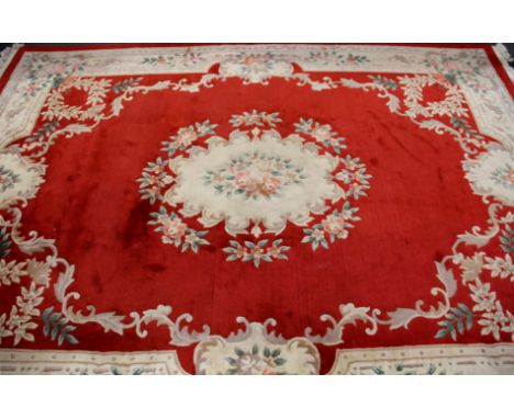 A large red ground Chinese washed wool carpet, 375 x 275.