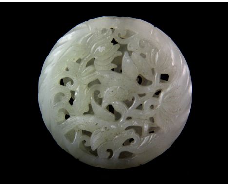 A fine Chinese mutton fat jade deeply pierced amulet decorated with a dragon and a phoenix, Dia. 5.5cm, Depth. 1.6cm.