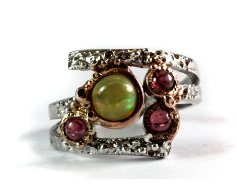 A Hana Maae designer 925 silver gilt ring set with a fire opal and rodhalite garnets, (Q).