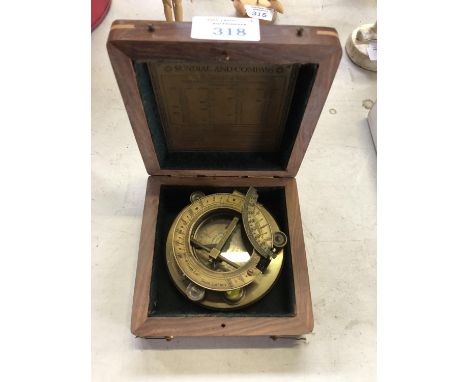 A WOODEN CASED BRASS SUNDIAL AND COMPASS BY J.H.STEWARD 