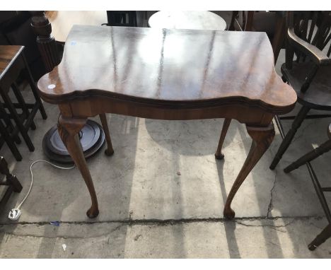 AN H SHAW, LONDON GAMES TABLE WITH REVOLVING AND FOLDING WALNUT TOP, GREEN BAIZE PLAYING SURFACE AND INNER GAMES COMPARTMENT 