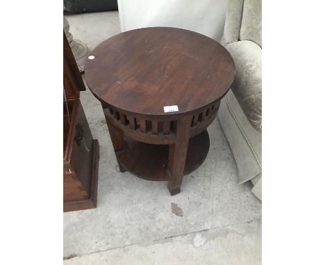 A HEAVY HARDWOOD OCCASIONAL TABLE WITH FRETWORK SIDES AND LOWER SHELF 