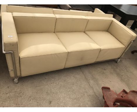 A MODERN CREAM LEATHER THREE SEATER SOFA ON TUBULAR CHROME SUPPORTS 210 CM X 78 CM X 67 CM HIGH 