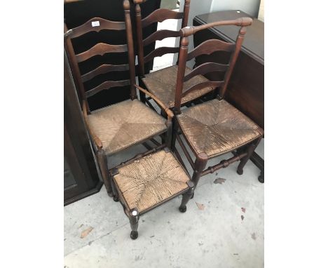 TWO MACCLESFIELD OAK LADDER BACK ARMCHAIRS WITH RUSH SEATS TOGETHER WITH A MATCHING CARVER AND FOOTSTOOL 