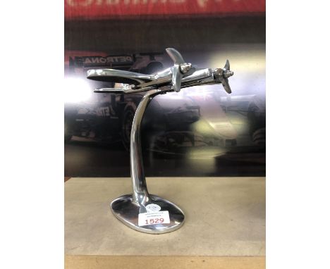 A CHROME MODEL OF A FIGHTER PLANE 