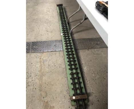 A 1 3/4 INCH GAUGE MODEL TRAIN TRACK ON WOODEN BOARD 
