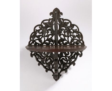 Victorian carved bracket, with quatrefoil form pierced scroll and foliate carved back, mahogany demilune shelf on a scroll an