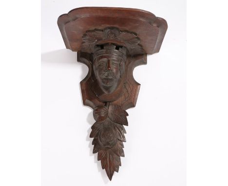 Oak bracket, the shaped shelf top on a support carved with depiction of a crowned gentleman above fruit and leaves