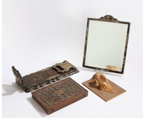 Lacquered framed mirror with bevelled plate, Goanese scroll carved wooden box, brass mounted adjustable book shelf, carved ra