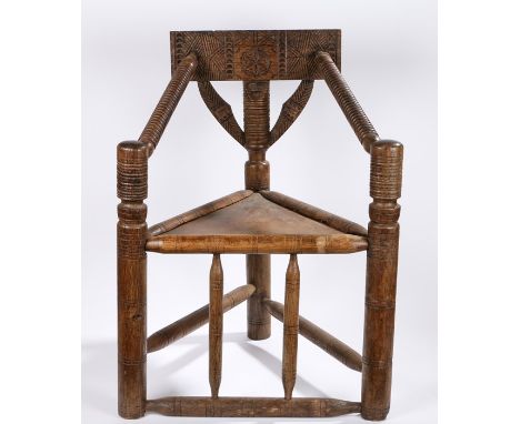 Carved oak turner chair, with geometric carved splat back, ring turned arms, panelled seat, on turned legs and stretchers