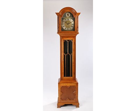 20th Century chiming oak cased longcase clock, the arched hood above a astragal glazed trunk door and panel base, the dial wi