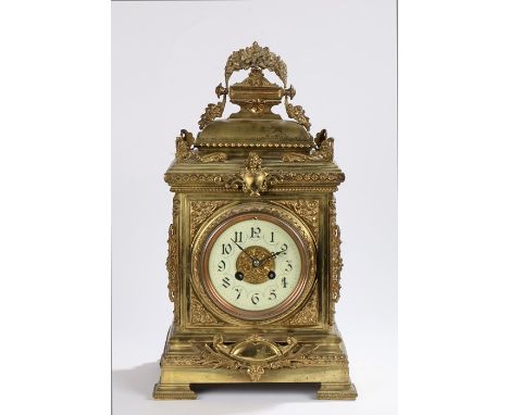 French gilt metal bracket clock, the foliate handle above a domed case with further foliating scrolling decoration above brac