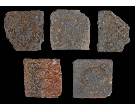 Five 13/14th Century tiles, four tiles of similar pattern of fleur d'lis to the four corners and petals enclosed within a cir
