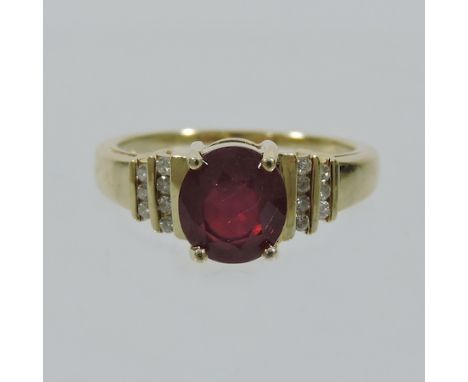 A 14 carat gold ruby and diamond dress ring, boxed