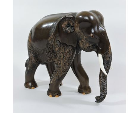 A carved hardwood model of an elephant, 31cm tall