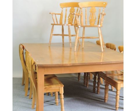 A modern large light oak dining table, with frieze drawers, 244 x 151cm, together with eight oak dining chairs, and two beech