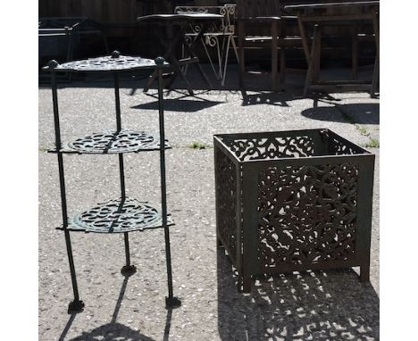 A cast iron green painted three tier pot stand, 62cm tall, together with a cast iron planter