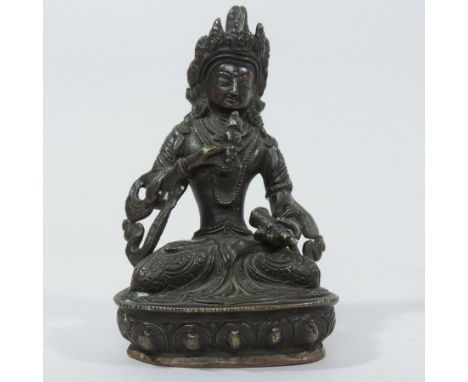 A South East Asian bronze figure of a seated Thai Buddha, with crossed legs, on a shaped plinth base, incised with a flowerhe