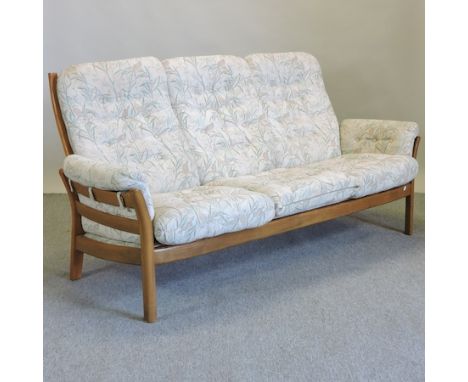 An Ercol light elm sofa, with floral upholstered cushions, 190cm