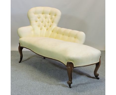 A Victorian carved mahogany and cream upholstered button back chaise longue, on cabriole legs