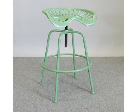 A green painted tractor seat stool