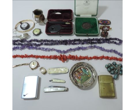 A collection of items to include amethyst bead and coral necklaces, a silver and mother of pearl fruit knife, a silver mounte