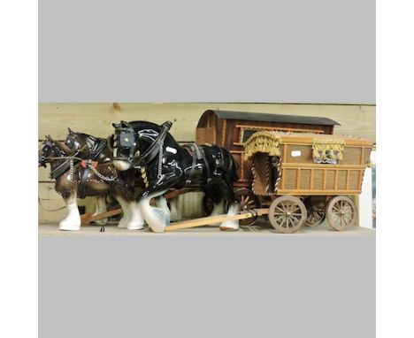 A collection of pottery cart horses, tallest 26cm, together with two model caravans
