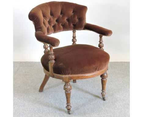 A 19th century mahogany and brown upholstered button back library chair