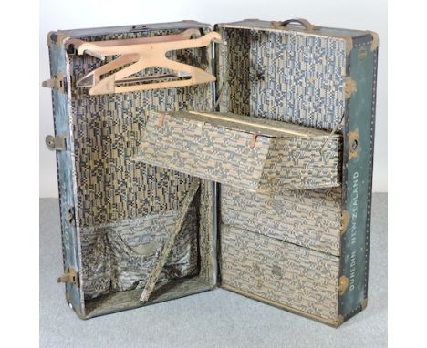 An early 20th century American steamer trunk, the fitted interior with coathangers and drawers, by the Newark Trunk Company, 