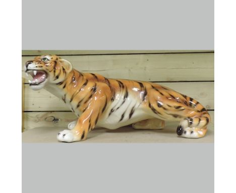 A large continental pottery model of a tiger, 33cm tall