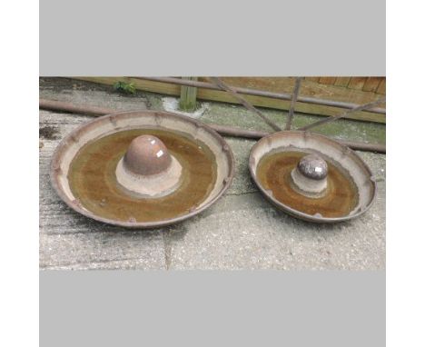 A cast iron circular pig trough, 92cm diameter, together with another smaller