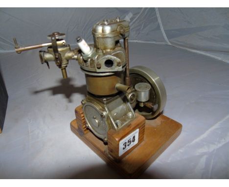 MODEL FUEL POWERED&nbsp; ENGINE 13 CM TALL ON A WOODEN&nbsp; PLINTH EST[£40-£60]