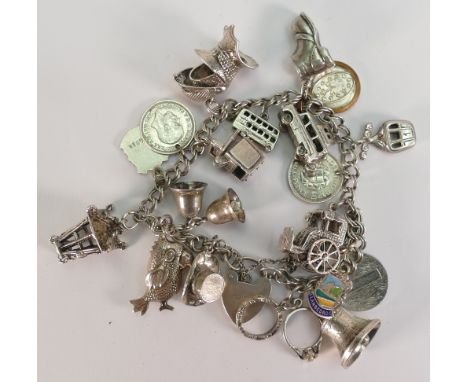 Silver charm bracelet with 19 charms, 56.4 grams.