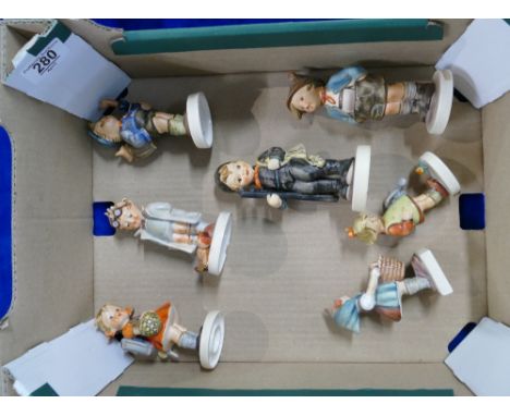Seven Goebel Hummel figurines: Girl with a basket ( bas and legs glued), boy doctor, boy with umbrella, boy with ladders( lad