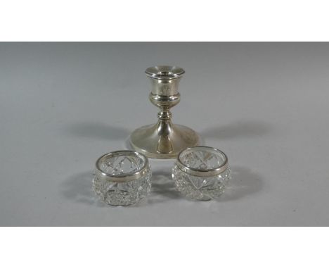 A Silver Candle Stick, 9.5cm high Together with Two Silver Topped Glass Salts, 5cm Diameter 