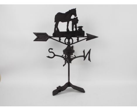 A cast iron weather vane with horse and blacksmith decoration, approximately 65 cm (h), appears in good condition (this does 