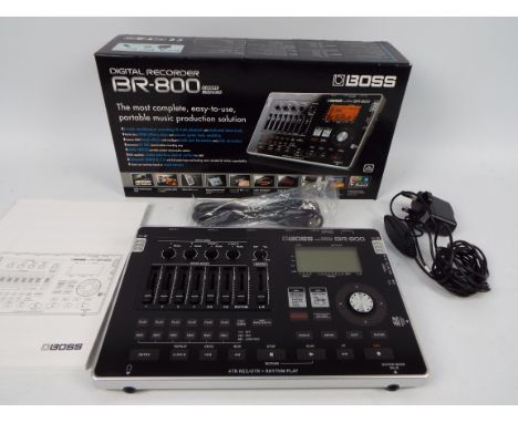 BOSS - A boxed Boss BR-800 digital recorder. 4 track simultaneous recording, 8-track playback, with dedicated drum track. Com