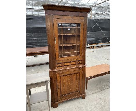 A GEORGE III STYLE OAK AND MAHOGANY CROSSBANDED CORNER CABINET ON BRACKET FEET WITH GLAZED UPPER PORTION, SMALL DRAWER, TWO S