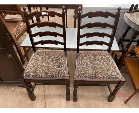 TWO OAK LADDER BACK DINING CHAIRS AND A FORMICA TOPPED COFFEE TABLE 