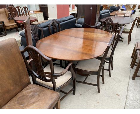 A MAHOGANY EXTENDING DINING TABLE ON TWIN PEDESTAL SUPPORTS WITH SIX SHIELD BACK DINING CHAIRS 