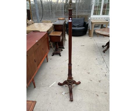 A REPRODUCTION CARVED MAHOGANY STANDARD LAMP ON TRIPOD BASE 